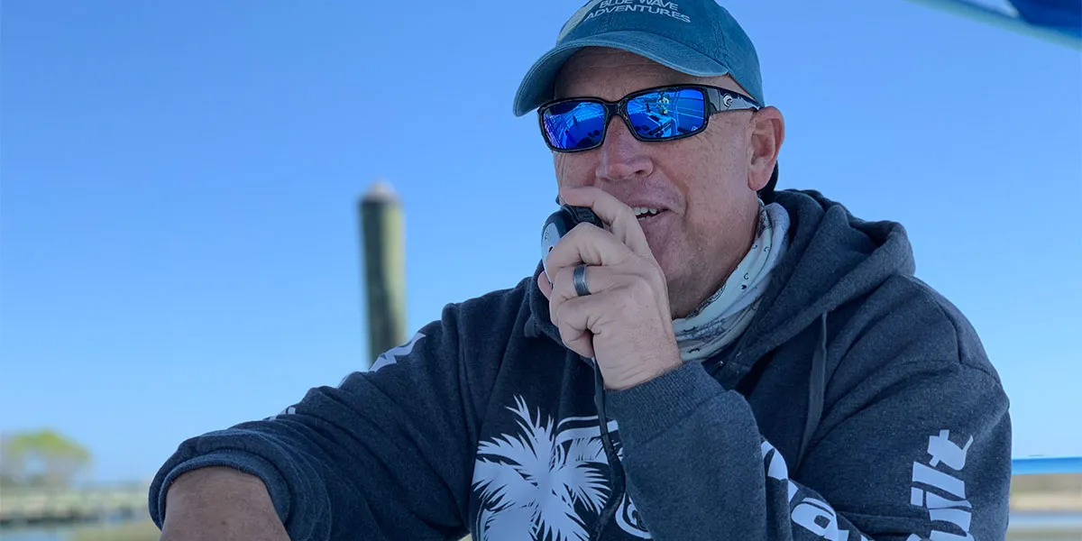 a man wearing a hat and sunglasses talking on a cell phone a man wearing a hat and sunglasses talking on a cell phone