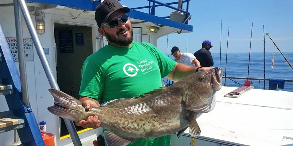 a man holding a fish a man holding a fish
