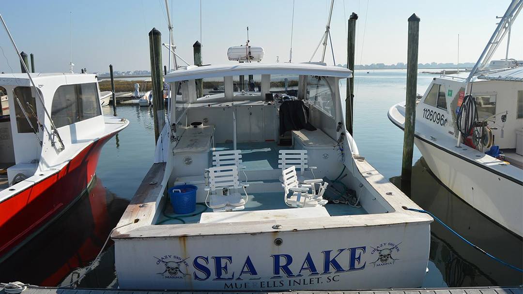 a boat is docked next to a body of water a boat is docked next to a body of water