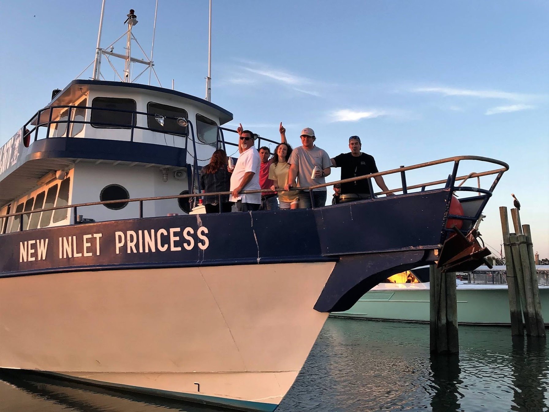 a group of people in a boat on a body of water a group of people in a boat on a body of water