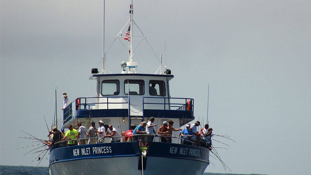 a group of people in a boat on a body of water a group of people in a boat on a body of water