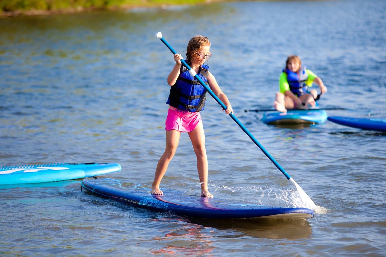 a little girl riding on the back of a boat in the water a little girl riding on the back of a boat in the water