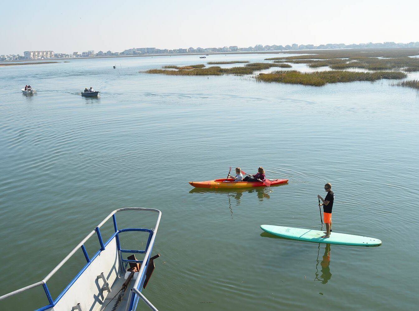 a group of people in a boat on a body of water a group of people in a boat on a body of water