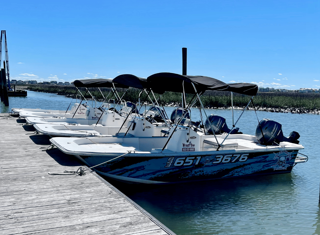 CSM Carolina Skiff a boat is docked next to a body of water