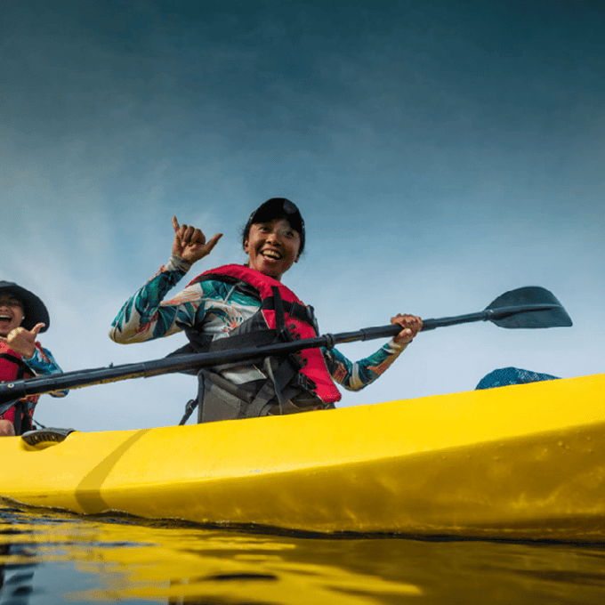a group of people riding on the back of a boat