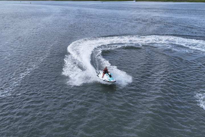 a man riding a wave on top of a body of water