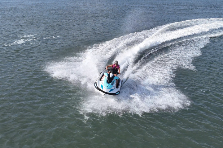 a man riding a wave on top of a body of water