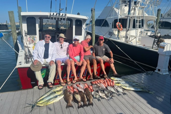 a group of people standing on a boat