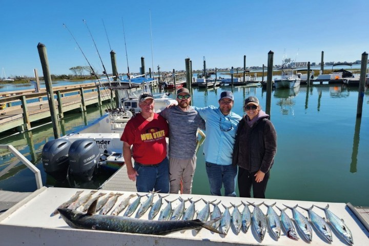 a group of people standing on a boat