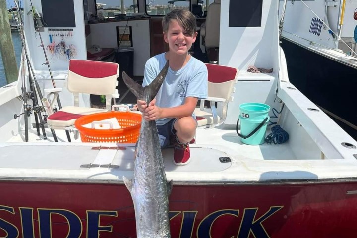 a man riding on the back of a boat