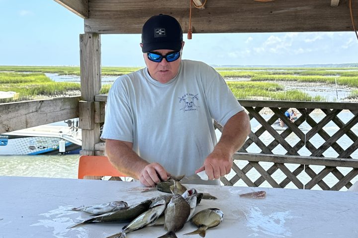 a man holding a fish