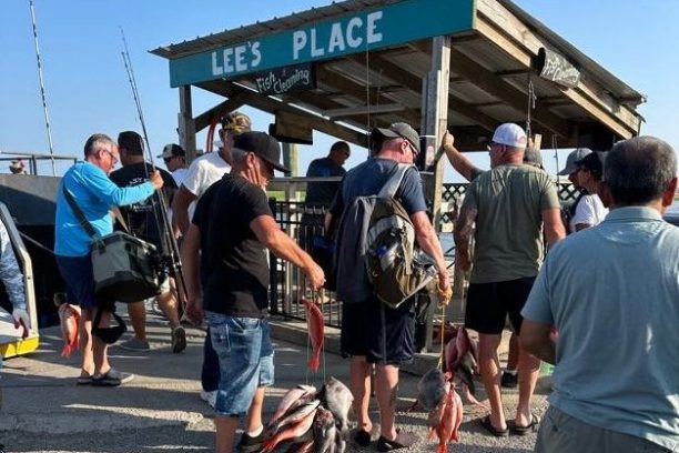 a group of people standing in a parking lot
