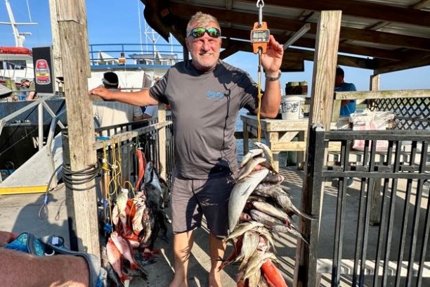 a man standing next to a boat
