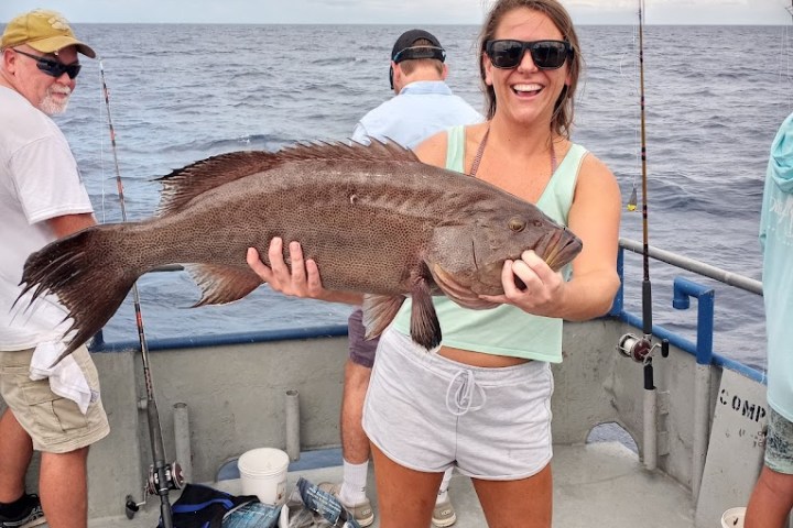 a person holding a fish in the water