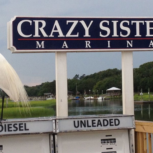 a sign in front of a body of water