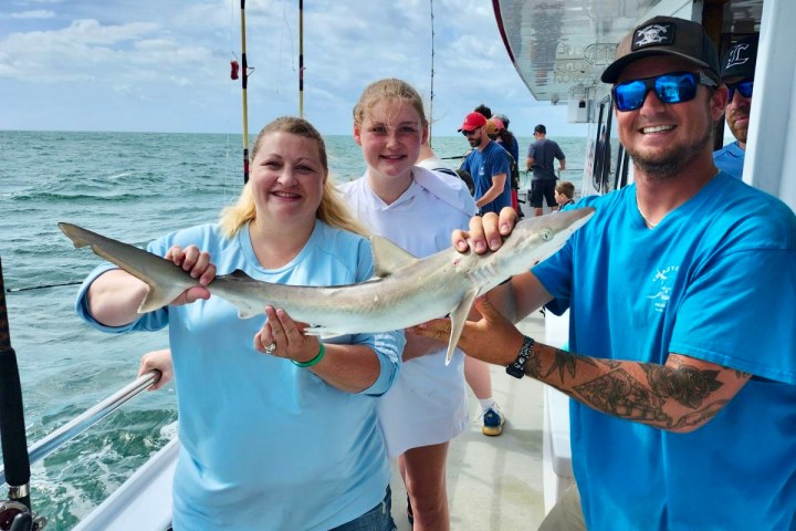 a person holding a fish in the water