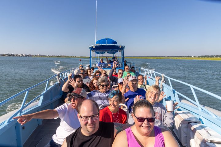 a group of people in a boat on a body of water