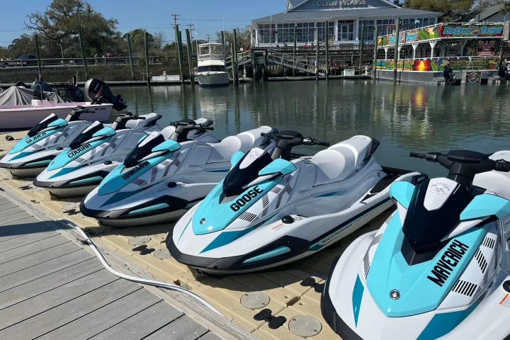 a row of parked motorcycles sitting on the beach