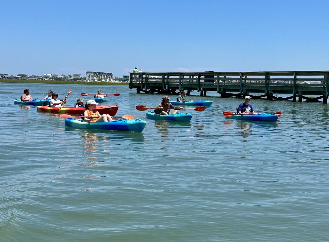 a group of people rowing a boat in the water