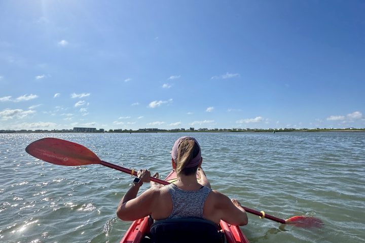 a person standing next to a body of water