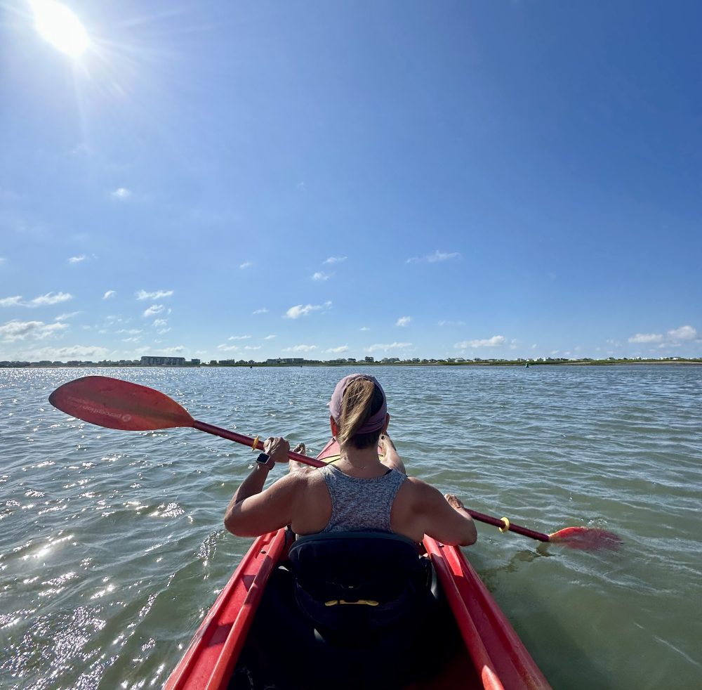 a person standing next to a body of water