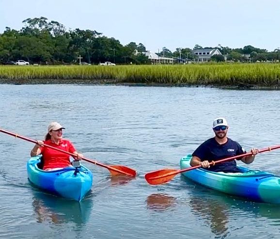 a group of people rowing a boat in a body of water