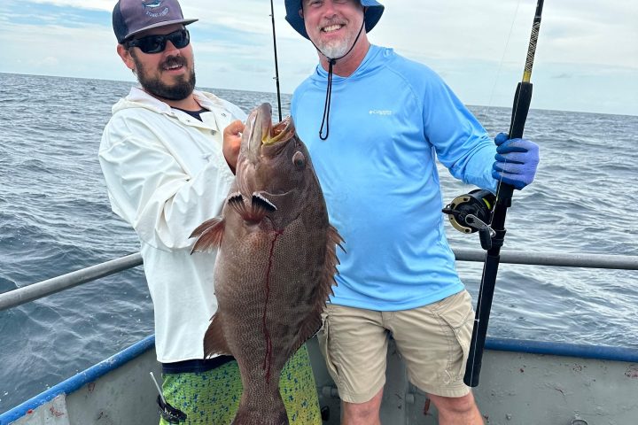 a man holding a fish in the water