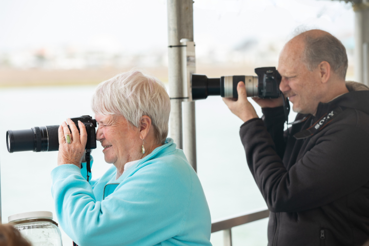 a group of people looking at a cell phone