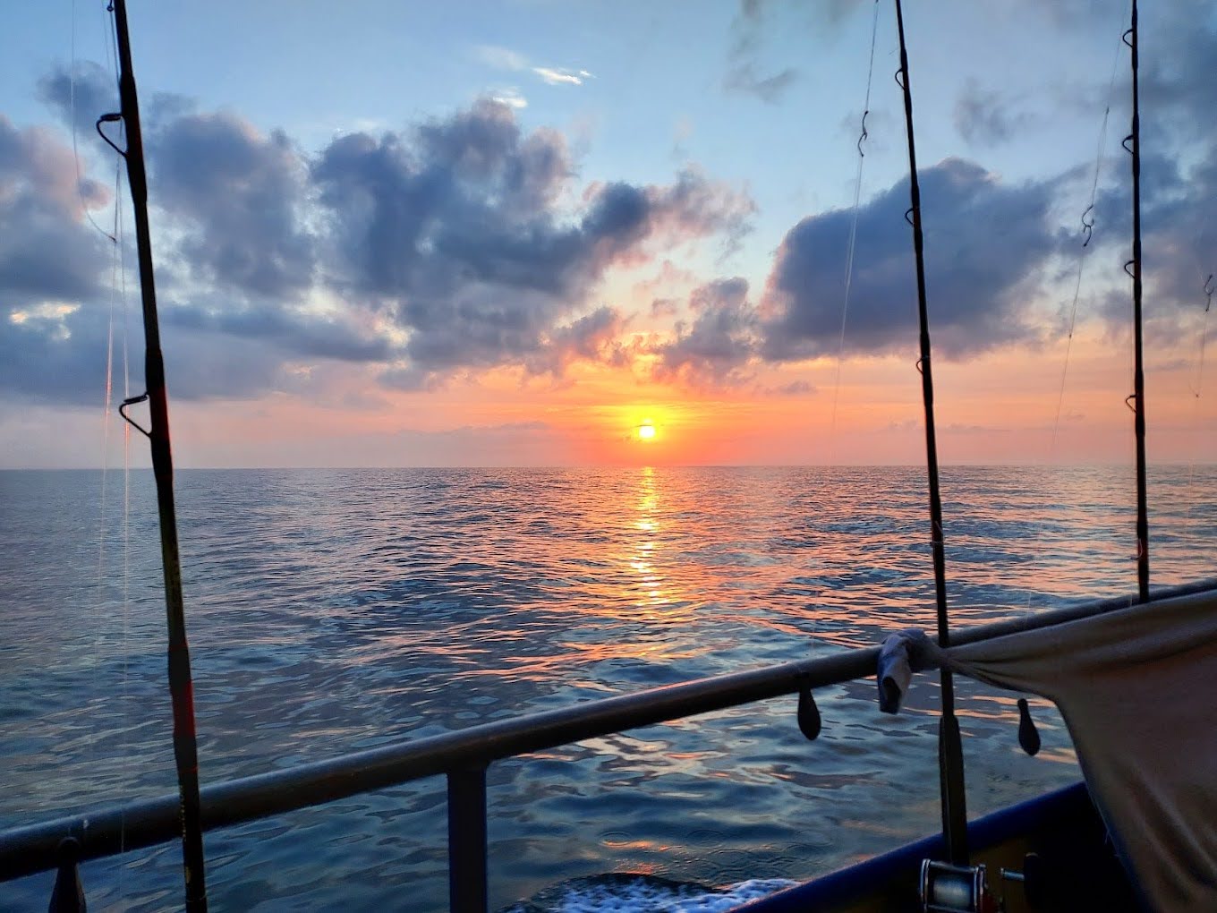 NIP Sunset from boat A vibrant sunset over Murrells Inlet during Crazy Sister Marina’s evening fishing charter experience.