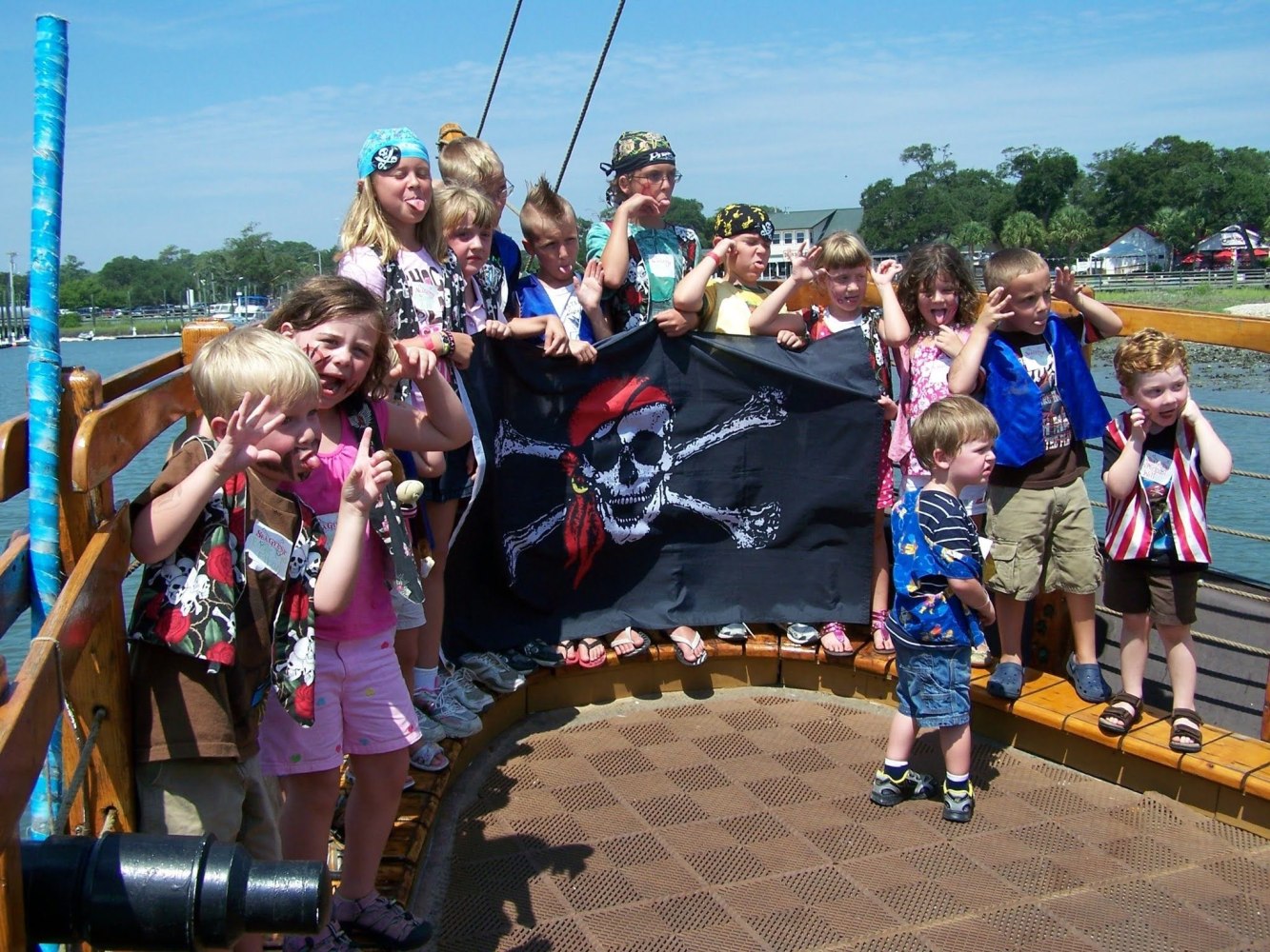 A group of kids laughing and having fun aboard Crazy Sister Marina’s pirate ship cruise.