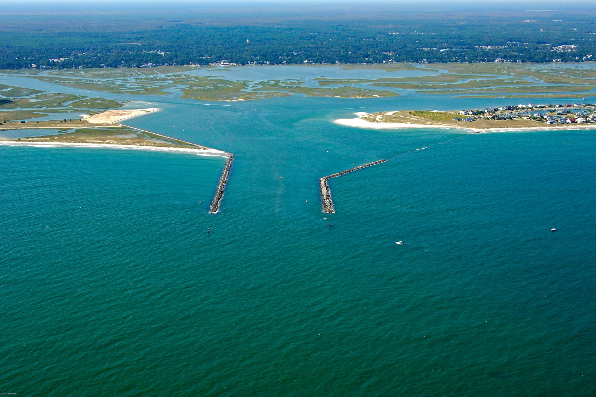 murrells inlet jetties looking into marshwalk Aerial view of a coastal inlet with breakwaters and surrounding land and water.