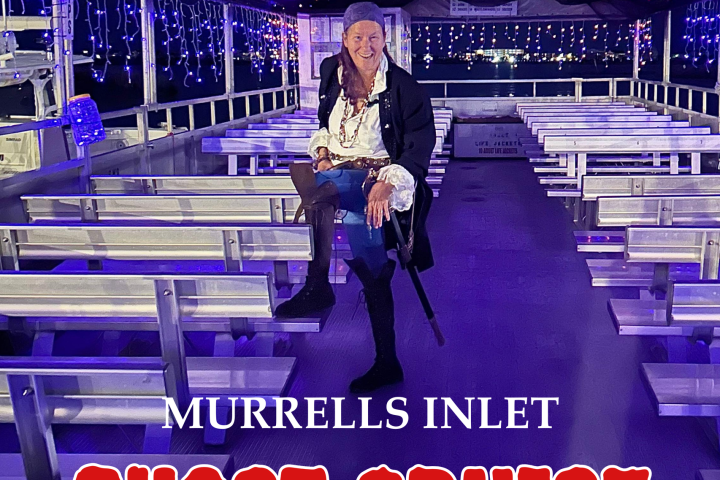 Pirate actor on a ghost-themed cruise ship with fairy lights and promotional text.