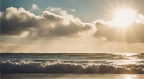 Sunset over ocean waves with clouds in the sky.